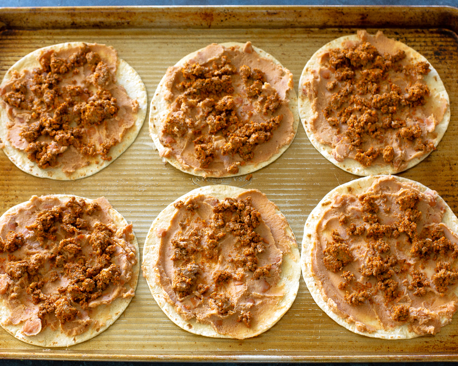 beans and taco meat on tortillas